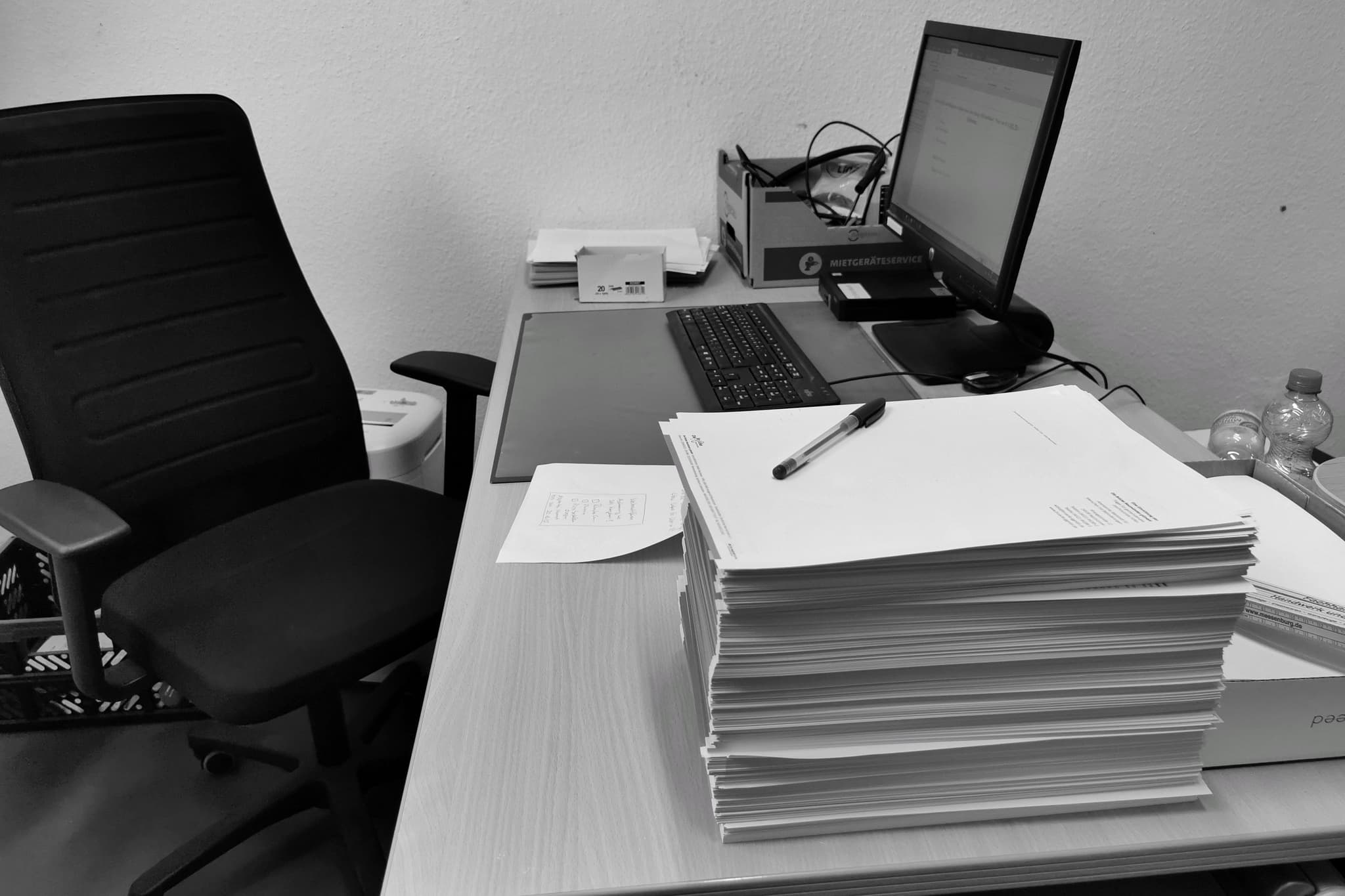 A practitioner at a desk working through a return on two screens.
