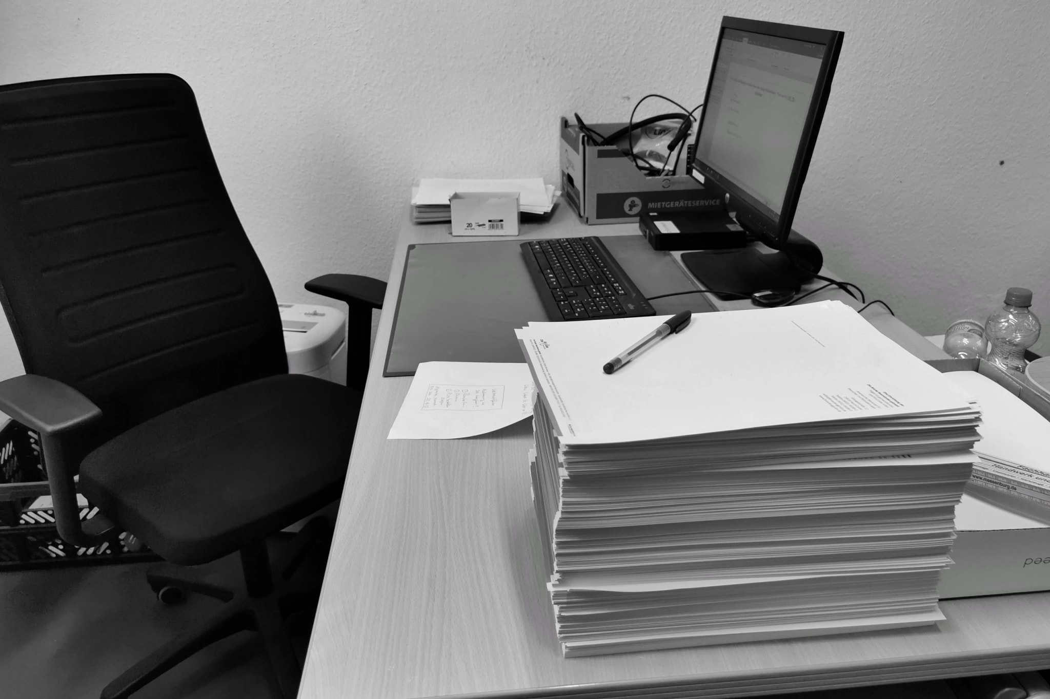 A practitioner at a desk working through a return on two screens.