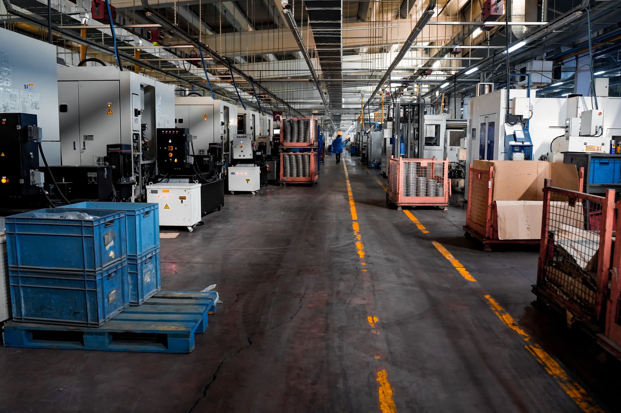 Operators on a production floor working beside a running line.